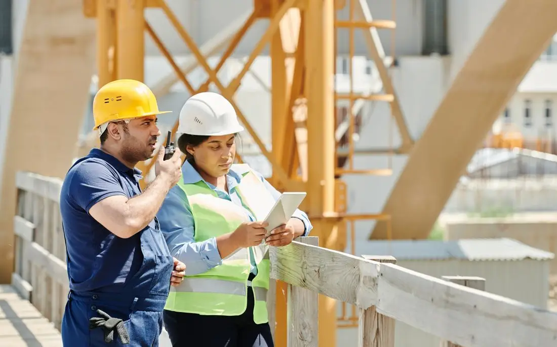 Site team checking figures on a phone and tablet