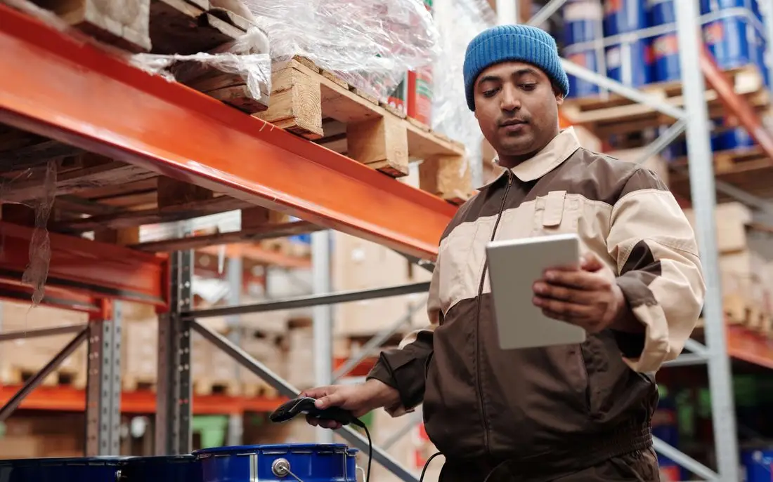 Buyer checking stock on a tablet in a warehouse